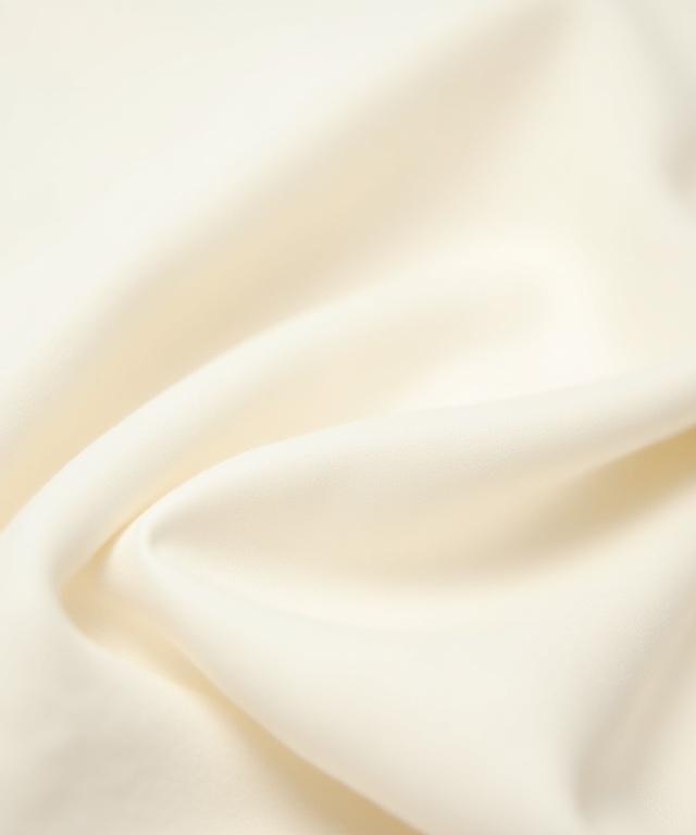 An extreme close-up view revealing the beautiful, natural slub and texture of a piece of raw Irish linen fabric, rich in organic detail.